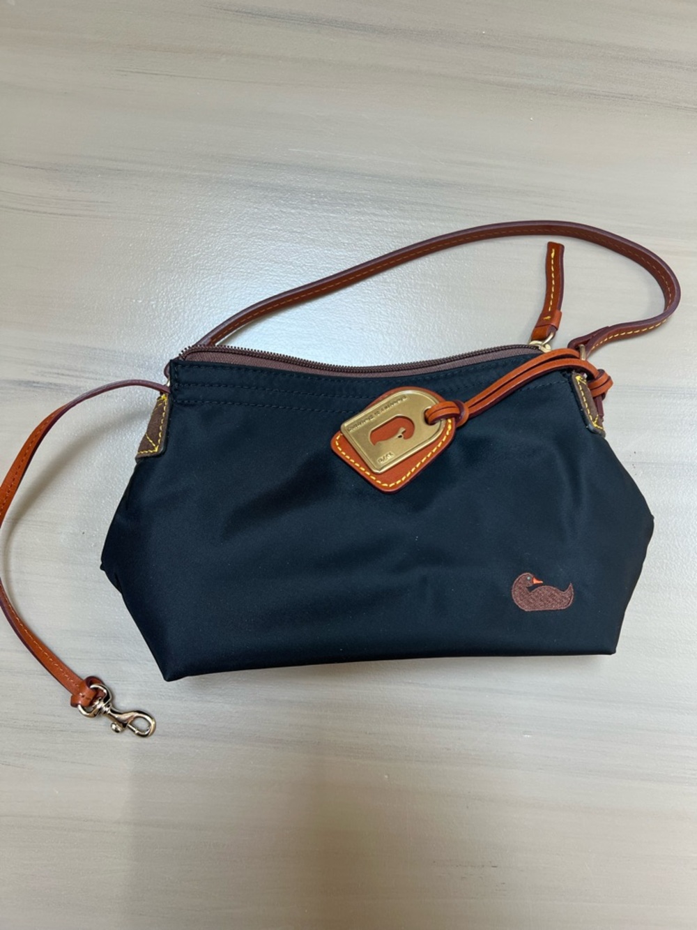 Dooney & Bourke Black Pouchette with Brown Leather Trim and Gold Accent
